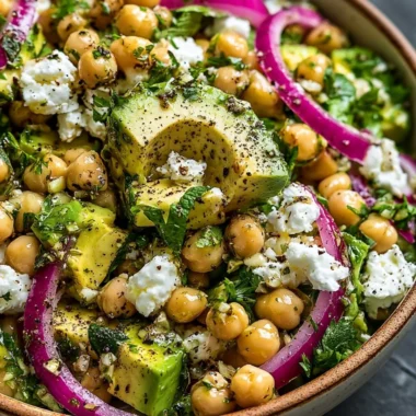 Chickpea Feta Avocado Salad with fresh vegetables and a drizzle of dressing