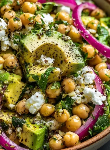 Chickpea Feta Avocado Salad with fresh vegetables and a drizzle of dressing
