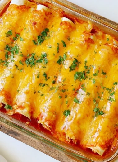 Delicious easy chicken sour cream enchiladas on a white plate