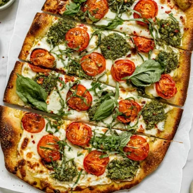 Homemade flatbread pizza with fresh toppings on a wooden board