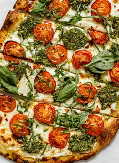 Homemade flatbread pizza with fresh toppings on a wooden board