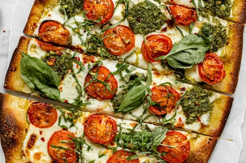 Homemade flatbread pizza with fresh toppings on a wooden board