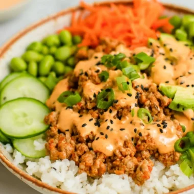 Ground turkey rice bowl served with Bang Bang sauce and colorful veggies