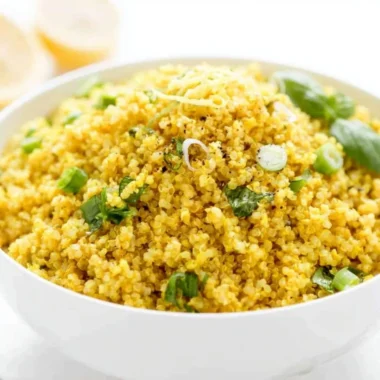 Vibrant Lemon Turmeric Quinoa bowl garnished with herbs and lemon slices