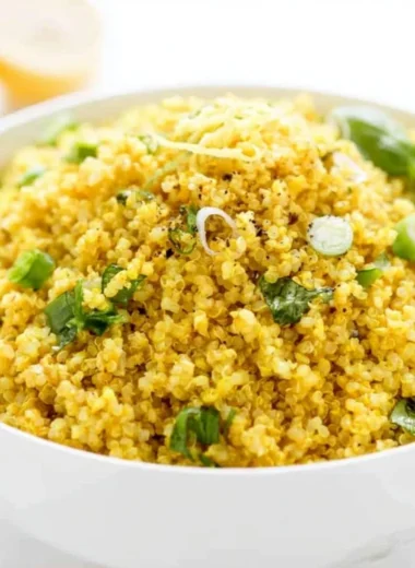 Vibrant Lemon Turmeric Quinoa bowl garnished with herbs and lemon slices