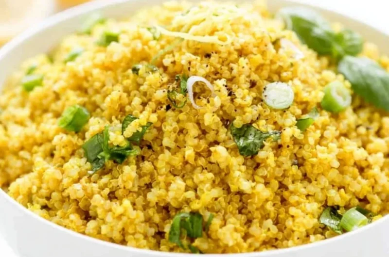 Vibrant Lemon Turmeric Quinoa bowl garnished with herbs and lemon slices