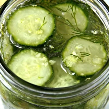 Jar of homemade overnight ranch seasoned pickles with fresh herbs and spices