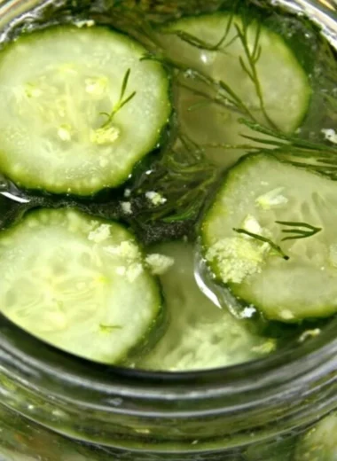Jar of homemade overnight ranch seasoned pickles with fresh herbs and spices