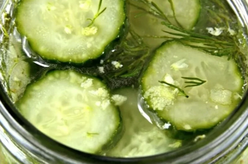 Jar of homemade overnight ranch seasoned pickles with fresh herbs and spices