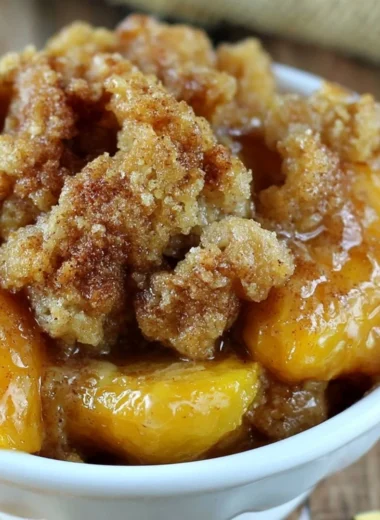 Delicious homemade Peach Crisp topped with oat crumble and fresh peaches