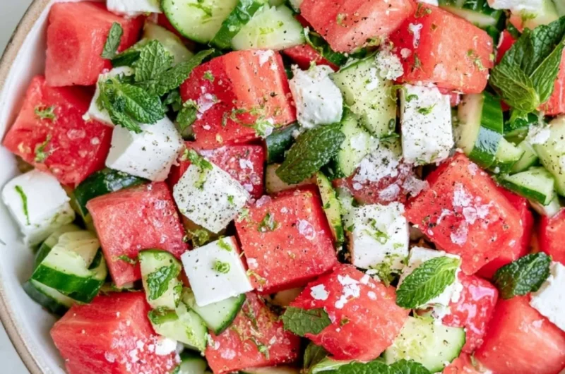 A vibrant watermelon cucumber feta salad served in a bowl with fresh ingredients.
