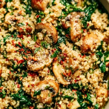 Bowl of Spinach Mushroom Quinoa garnished with fresh herbs