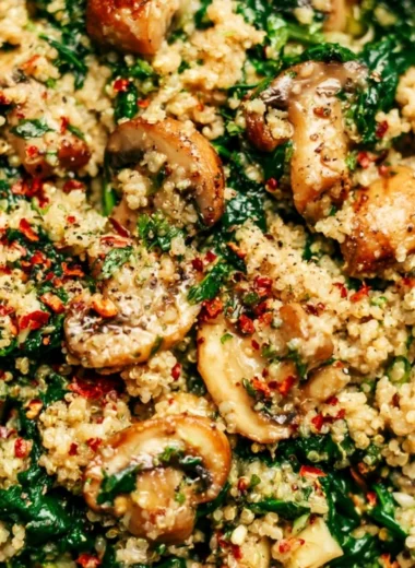 Bowl of Spinach Mushroom Quinoa garnished with fresh herbs