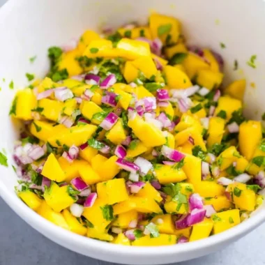 Fresh mango salsa made with ripe mangoes, cilantro, and lime