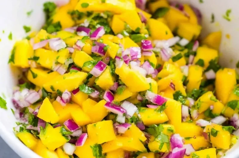 Fresh mango salsa made with ripe mangoes, cilantro, and lime