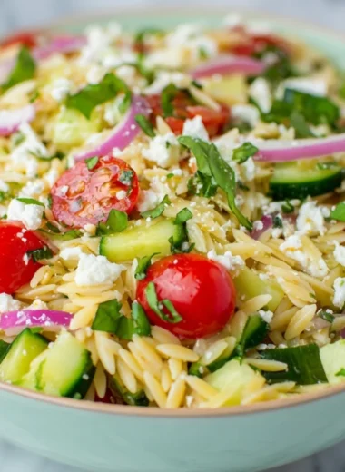 Delicious orzo pasta salad with fresh ingredients and vibrant colors