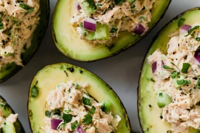 Tuna stuffed avocados served on a plate, highlighting a healthy meal option.