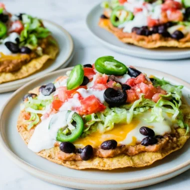 Delicious Vegetarian Tostadas topped with fresh vegetables and sauces