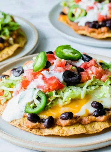 Delicious Vegetarian Tostadas topped with fresh vegetables and sauces