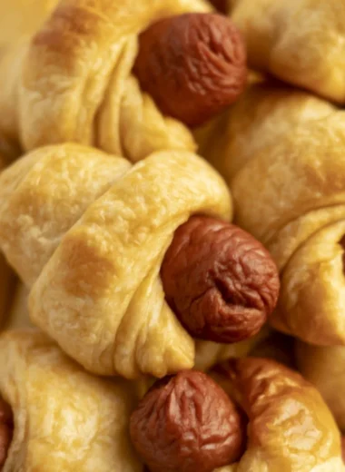Delicious air fryer pigs in a blanket served with dipping sauce on a plate