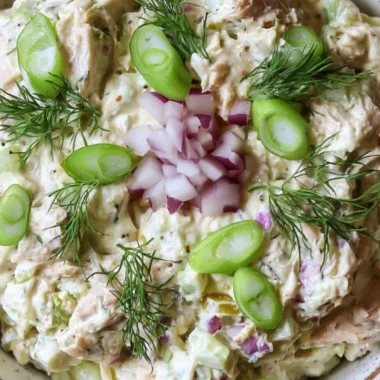 Cottage Cheese Tuna Salad garnished with fresh herbs on a plate.