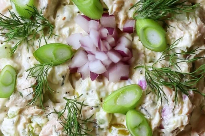 Cottage Cheese Tuna Salad garnished with fresh herbs on a plate.