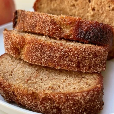 Cozy apple cider loaf baked with spice and sweetness, served on a wooden table.