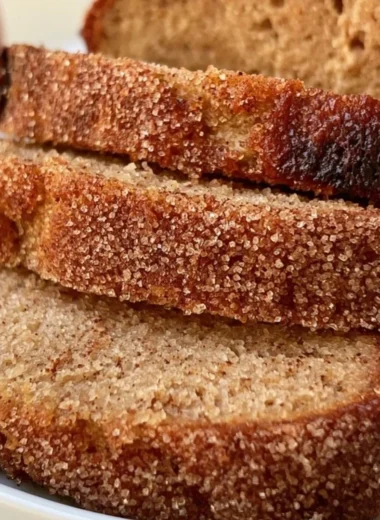 Cozy apple cider loaf baked with spice and sweetness, served on a wooden table.