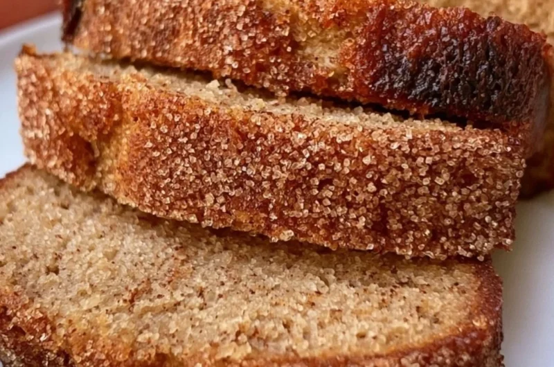 Cozy apple cider loaf baked with spice and sweetness, served on a wooden table.