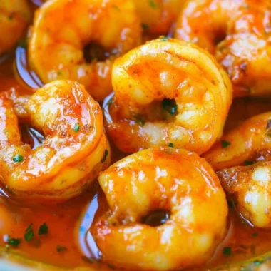 A plate of Cozy Cajun Shrimp garnished with fresh herbs and spices.