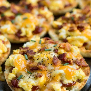 Delicious English Muffin Breakfast Pizzas topped with eggs, cheese, and veggies