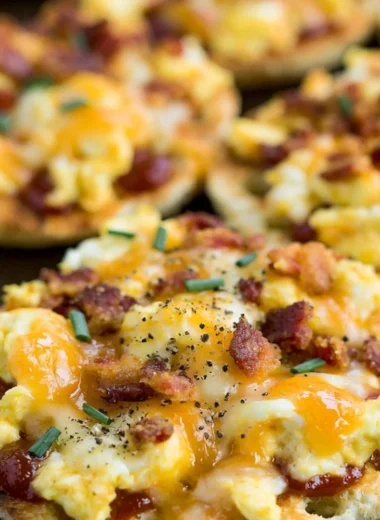Delicious English Muffin Breakfast Pizzas topped with eggs, cheese, and veggies