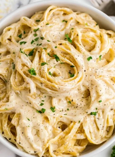 Homemade Alfredo sauce in a saucepan ready to serve with pasta.