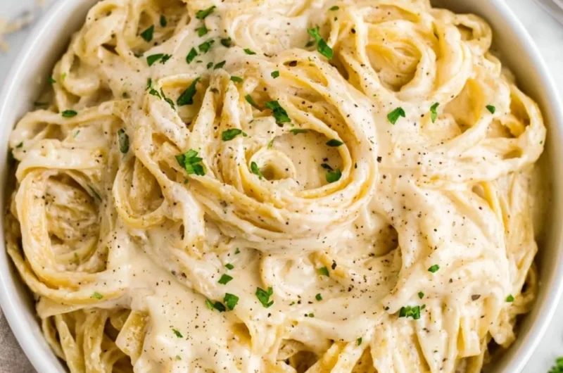 Homemade Alfredo sauce in a saucepan ready to serve with pasta.