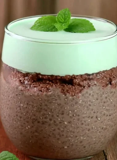 Mint chocolate chia pudding topped with fresh mint leaves and chocolate shavings.