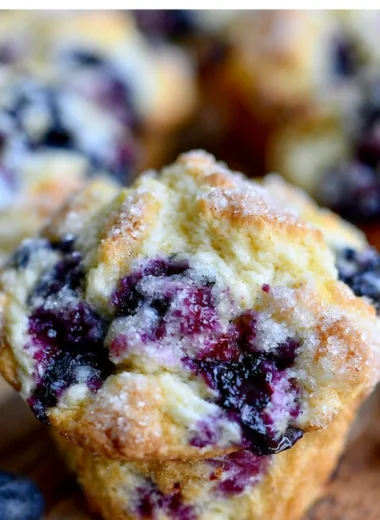 Freshly baked Meyer Lemon Blueberry Muffins with a zesty lemon glaze.
