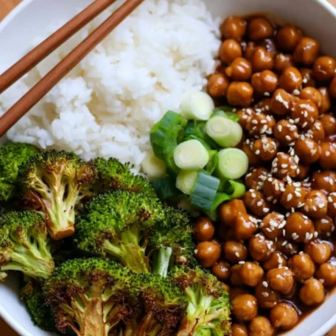 Cozy General Tso's Chickpeas served in a bowl with broccoli and rice