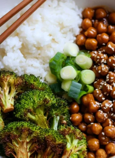 Cozy General Tso's Chickpeas served in a bowl with broccoli and rice