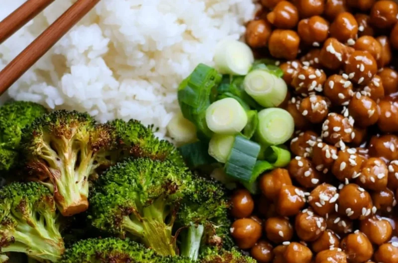 Cozy General Tso's Chickpeas served in a bowl with broccoli and rice