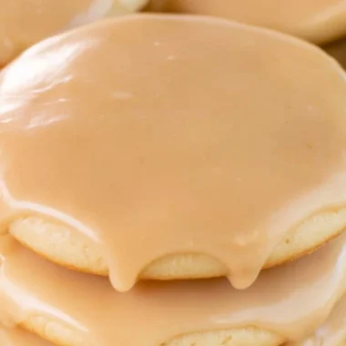 Cozy Maple Cookies decorated with maple icing on a wooden table