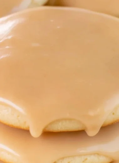 Cozy Maple Cookies decorated with maple icing on a wooden table