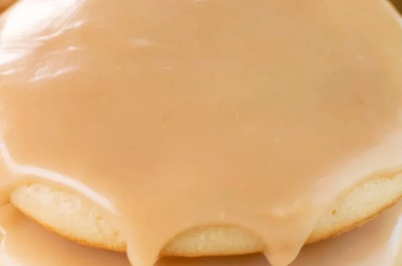 Cozy Maple Cookies decorated with maple icing on a wooden table