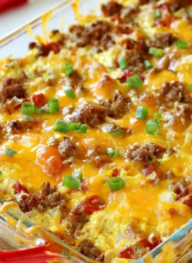 Cozy Sausage Egg Bake served in a casserole dish with fresh herbs