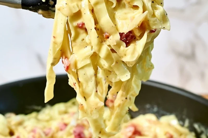 Creamy cabbage carbonara dish garnished with parsley and cheese