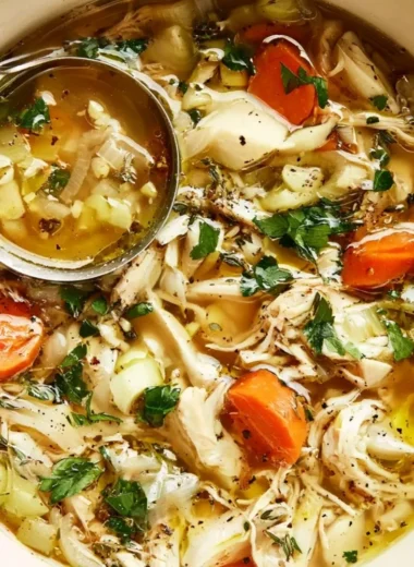 Bowl of easy and healthy homemade chicken soup with vegetables and herbs