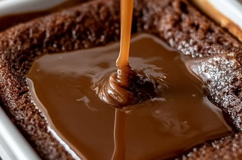Delicious sticky toffee pudding served with creamy sauce and a sprig of mint
