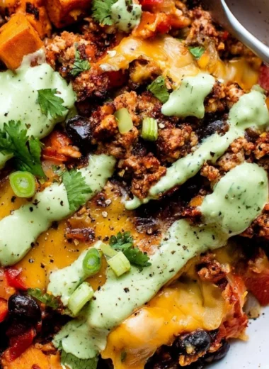 Delicious Sweet Potato Turkey Black Bean Bake topped with fresh herbs
